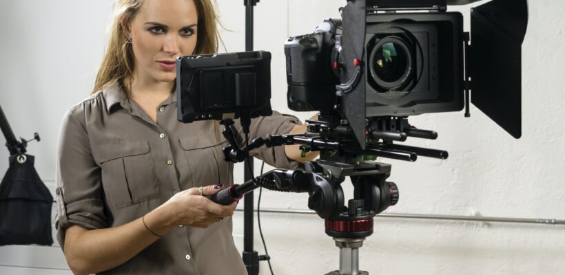 Beautiful woman operating a video camera rig